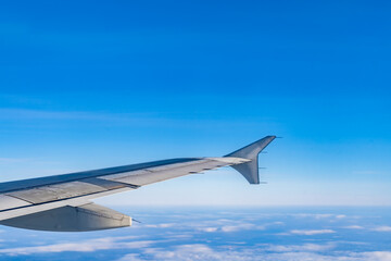 Beautiful view from the airplane porthole. blue sky, clouds, earth.