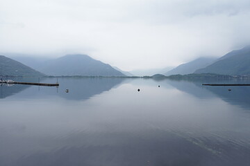 View of a glmpse of Lake Como from the lakefront promenade of Domaso. Lake Como, Domaso, Italy