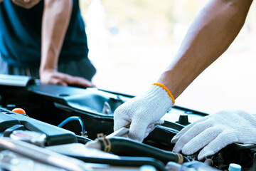 Auto mechanic working on car engine