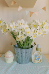 a vase of flowers with a baby shower on the table