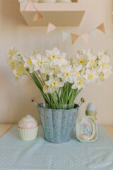 a vase of flowers with a baby shower on the table