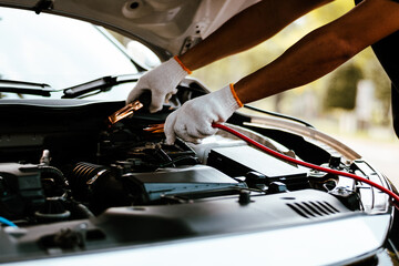 Charge your car battery with jumper cables.