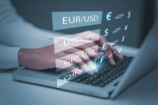 Currency exchange global financial banking interbank foreign exchange and payment concept, with a businessman holding currency and using a computer laptop with finger pointing at symbols. - Powered by Adobe
