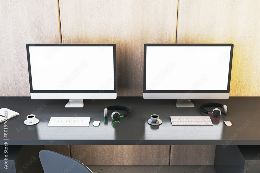 Poster two clean white gaming computer monitor on desk with coffee cups and headsets. place for your advert