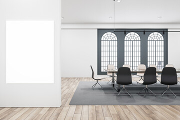 Modern meeting room with a large blank poster on the wall, contemporary furniture and large windows, on a wooden floor background, concept of workplace. 3D Rendering
