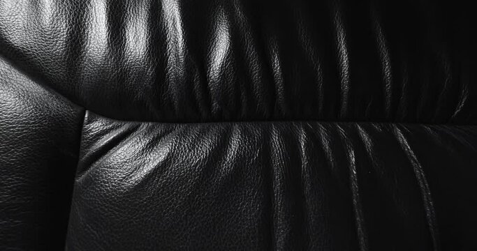 Black leather texture close up sliding move 

