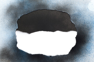 White paper with black spray stains with black and blue spray painted torn paper frame.