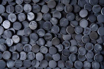 A seamless pattern filled with round tablets of activated carbon, creating a visually striking and textured design. The tablets are evenly distributed across the surface, forming a repeating pattern 