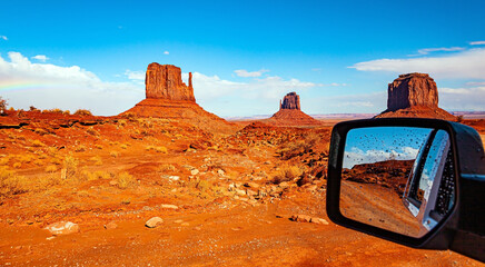 The car mirror reflects the landscape.