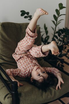 funny little girl play at home cheir