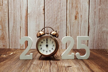 Happy New Year 2025 alphabet letter and Vintage alarm clock with space copy on wooden background
