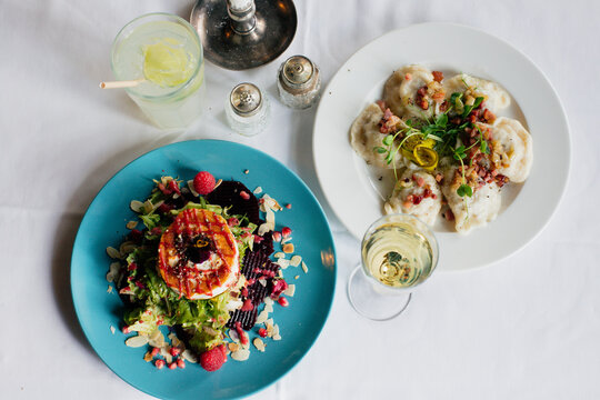 dumplings with meat and microgreens and salad with goat cheese