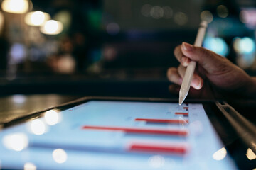 A businessman uses a digital tablet to view data