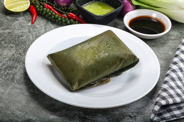 Asian cuisine - rice with filling in banana leaf