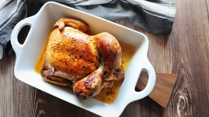 Roasted whole chicken with herbs in pan. Recipe dinner, christmas background