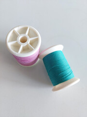 Fototapeta na wymiar Vibrant Assorted Bobbins Thread Spools, Sewing Essentials Collection.