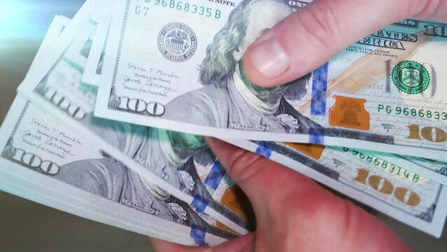 Man counting out dollar bills for an investment. Currency. Financial job concept. Concept of a deal.