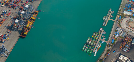 Aerial top view over international containers cargo ship at industrial import-export port prepare...