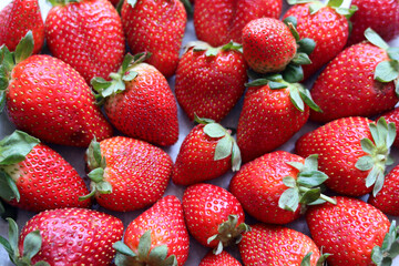 Red ripe strawberries background. Strawberry texture close up photo. Fresh organic berries macro. Eating fresh concept. 