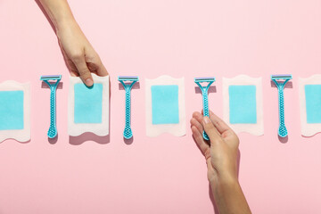 Razors for shaving with hair removal strips on a pink background