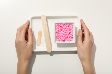White tray with pink granules for depilation