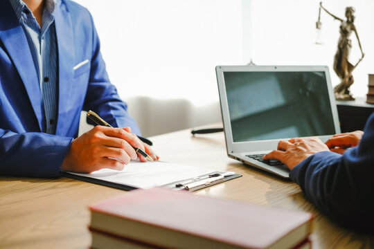 Legal expert navigating corruption cases, including bribery and graft. Businessman consults at desk. Discussions involve bribery, corruption, buying off, and corrupt practices.