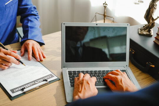 Legal expert navigating corruption cases, including bribery and graft. Businessman consults at desk. Discussions involve bribery, corruption, buying off, and corrupt practices.