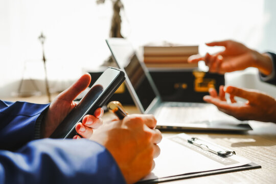 Legal expert navigating corruption cases, including bribery and graft. Businessman consults at desk. Discussions involve bribery, corruption, buying off, and corrupt practices.