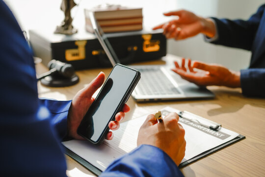 Legal expert navigating corruption cases, including bribery and graft. Businessman consults at desk. Discussions involve bribery, corruption, buying off, and corrupt practices.