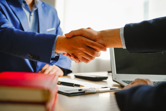 Legal expert navigating corruption cases, including bribery and graft. Businessman consults at desk. Discussions involve bribery, corruption, buying off, and corrupt practices.