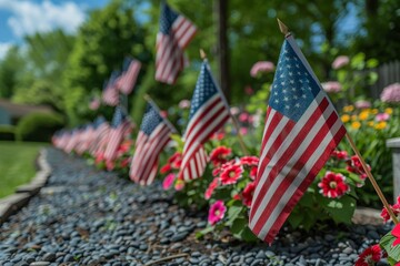 A row of American flags are planted in a garden