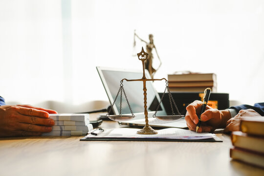 Legal expert navigating corruption cases, including bribery and graft. Businessman consults at desk. Discussions involve bribery, corruption, buying off, and corrupt practices.