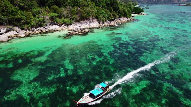 Summer trip to the sea and long-tail boats in the clear sea at Koh Lipe.