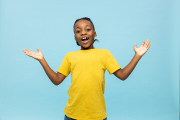 Dark-skinned boy in yellow tshirt looking excited and happy