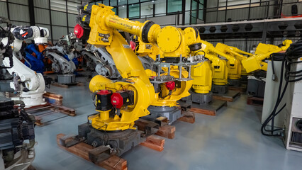 Engineers inspecting and check up machine of the automated arms machine welding robots at factory.