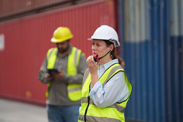 Foreman control loading containers box from cargo freight ship for import export, Foreman control industrial container cargo freight ship, Business logistic concept, Import and export concept