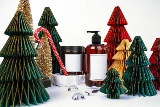 dark jar with lid and dispenser on the background of Christmas decorations, side view
