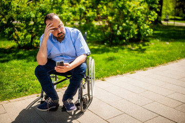 Portrait of man in wheelchair. He is worried and depressed.