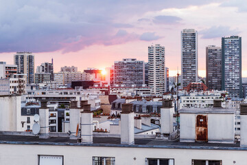 A breathtaking scene captures the sunset over Paris from the vantage point of a towering building,...