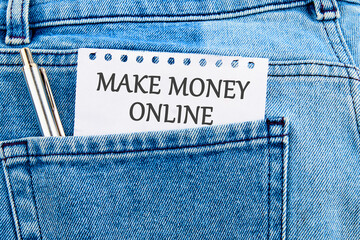 Business concept. MAKE MONEY ONLINE lettering written on a piece of paper that appeared from the...