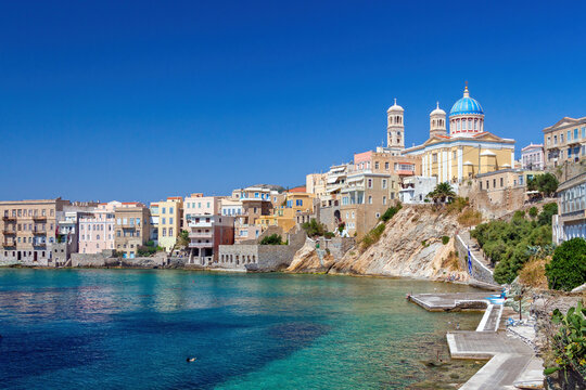 Beautiful Vaporia district, with its unique turquoise coast and colorful houses, in Ermoupoli town, Syros island, Cyclades, Greece, Europe.