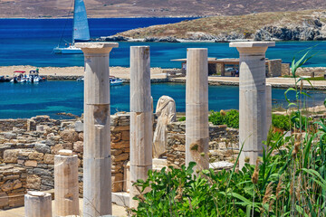 At the archaeological site of the "sacred" island of Delos, while at the background is Rineia island, in the Cyclades islands complex, Greece, Europe.