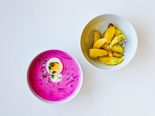 Cold Lithuanian soup Saltibarsciai, a cold summer soup made of beetroot and kefir, popular in Lithuania, Latvia, Poland and Belarus, served with baked potatoes