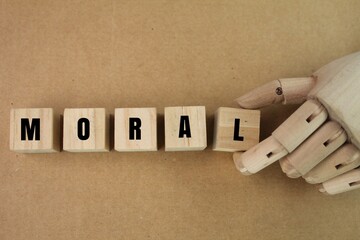 wooden cube with moral words. the concept of ethics or a person's entity