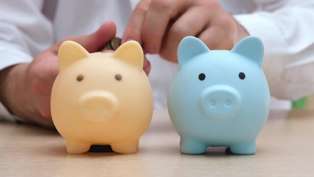 Male hand throws coins into two piggy banks in turn. Businessman diversifies his portfolio. Pension, savings, finance accounting diversification. Saving money, investments diversity concept