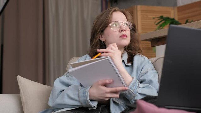 A serene environment envelopes a young woman as she studies her notebook, a laptop nearby. It speaks to the commitment to continuous learning in today's world.