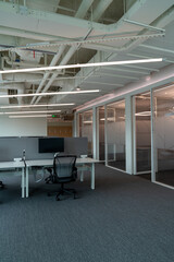 Interior of modern empty office building.Open ceiling design.Equipped with automatic lifting table and LCD screen.