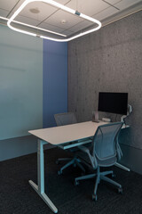 Interior of modern empty office building.Open ceiling design.Equipped with automatic lifting table and LCD screen.