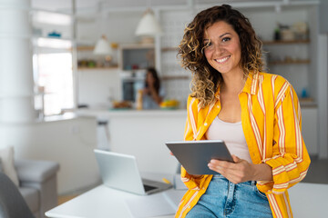Smiling confident businesswoman looking at camera standing at home. Home office. Modern stylish...