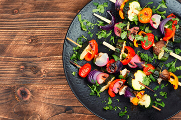 Grilled vegetables on skewers, space for text.